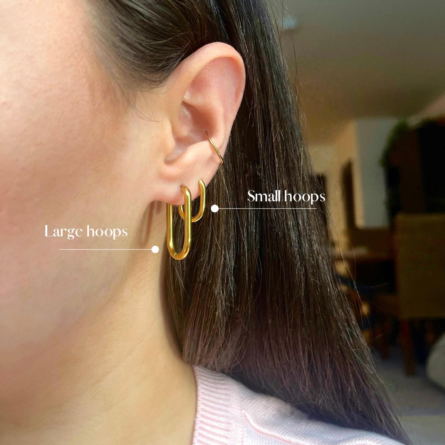 Close-up of an ear wearing gold hoop earrings with labels for 'Large hoops' and 'Small hoops'.
