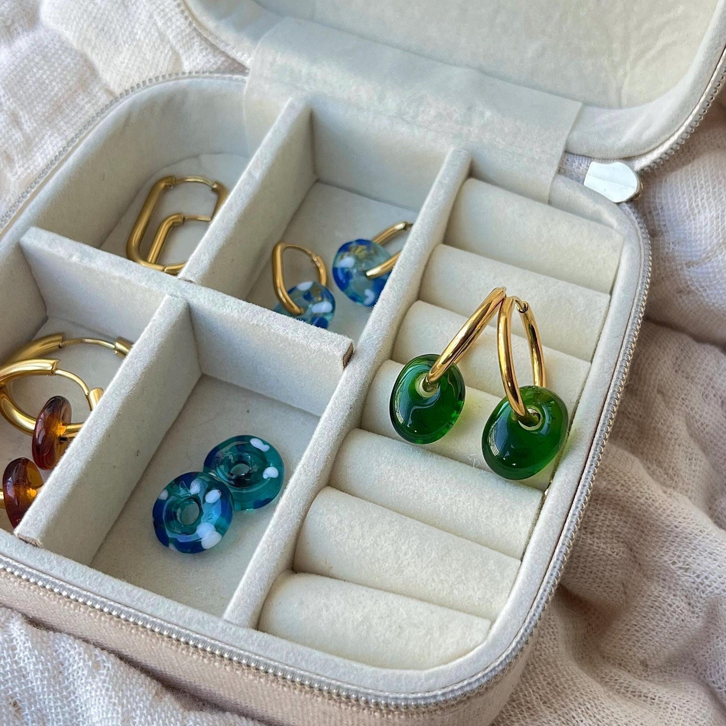 Jewelry case with green and blue hoop earrings